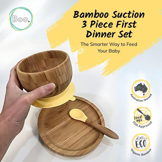 Bamboo suction 3 Piece First Dinner Set with a hand holding a bowl, on a white background with yellow accents.