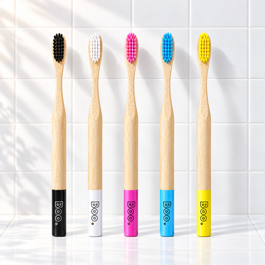Five Boo adult bamboo toothbrushes, one in each colour: black, white, pink, blue and yellow