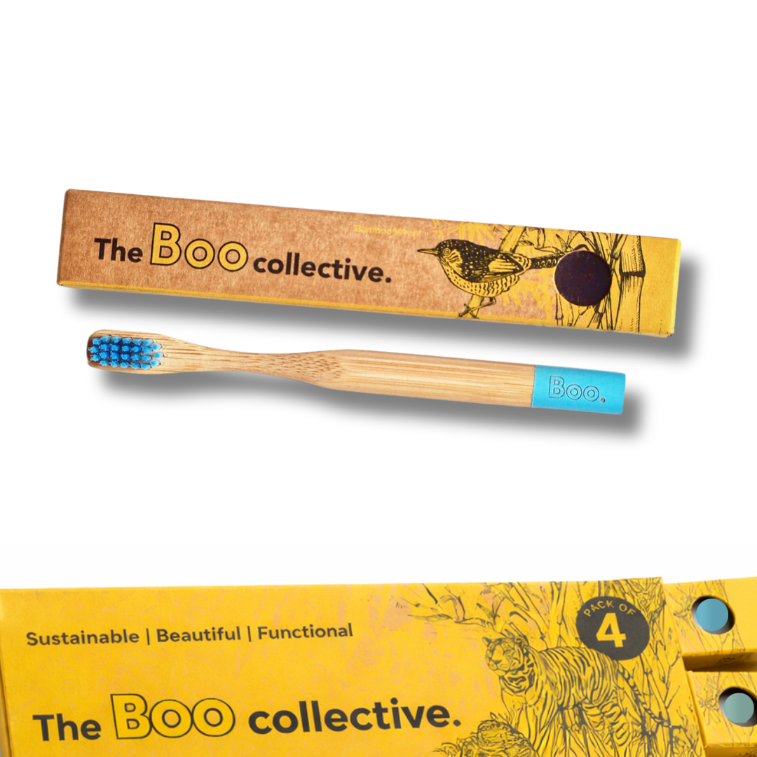 Bamboo toothbrush with blue bristles and packaging from The Boo collective on a white background