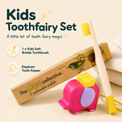 Kids Toothfairy Set by The Boo Collective, featuring a wooden elephant toothbrush holder, a pink and purple elephant toy, a soft bristle toothbrush with a wooden handle, and its kraft paper packaging box on a light beige background.