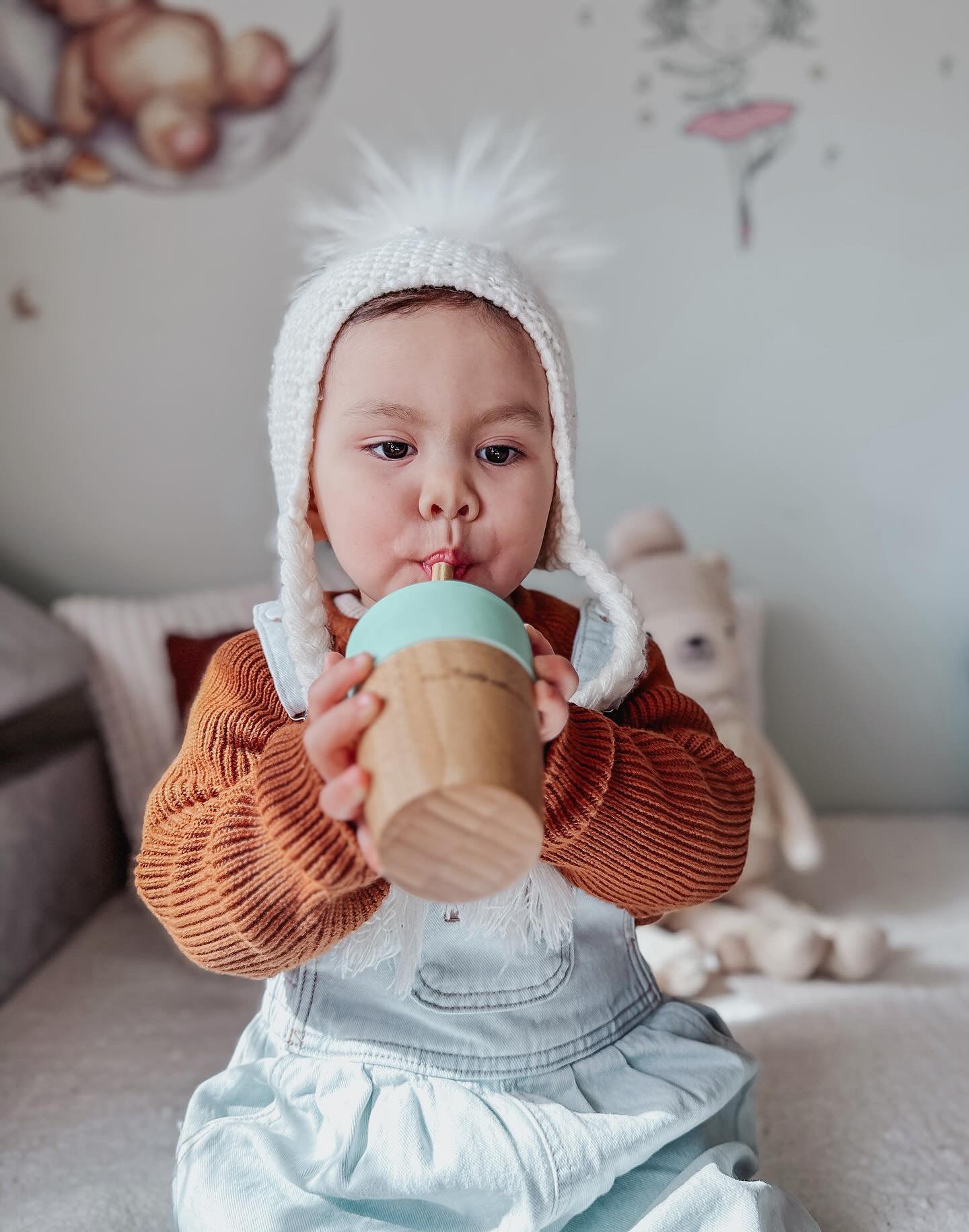 Older Baby drinking from bamboo straw cup