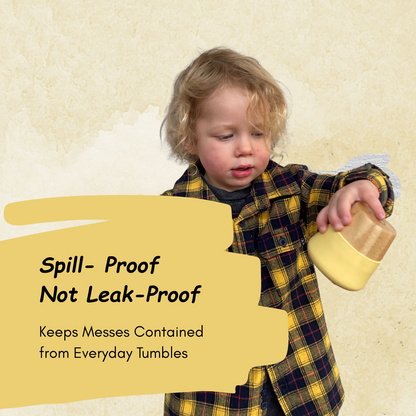Child in plaid shirt holding a container with text about spill-proof and leak-proof features on a beige background